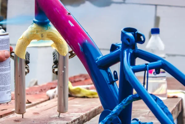 man-paints-bicycle-with-spray-paint